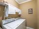 A laundry room featuring a washer, dryer, shelving, and a laundry rack at 4721 W Lakeshore Dr, Acworth, GA 30101