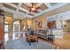 Open-concept living room featuring coffered ceilings, hardwood floors, and elegant furnishings at 4721 W Lakeshore Dr, Acworth, GA 30101