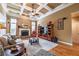 Cozy living room with a fireplace, coffered ceiling, and hardwood floors at 4721 W Lakeshore Dr, Acworth, GA 30101