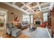 Inviting living room with coffered ceiling, hardwood floors, and a stone fireplace at 4721 W Lakeshore Dr, Acworth, GA 30101