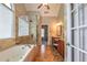 Luxurious main bathroom with a soaking tub, tiled floors and a seamless glass shower at 4721 W Lakeshore Dr, Acworth, GA 30101