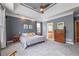 Elegant main bedroom with trey ceiling, ceiling fan, and ensuite bathroom access at 4721 W Lakeshore Dr, Acworth, GA 30101