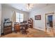 A comfortable office space with a desk, chair, computer, bookcase, window, and carpet at 4721 W Lakeshore Dr, Acworth, GA 30101