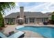 Beautiful pool area with lounge chairs, patio table and lush green landscaping at 4721 W Lakeshore Dr, Acworth, GA 30101