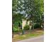 View of the back side of the house with a deck in the trees behind the home at 5580 Jamerson Dr, Atlanta, GA 30349