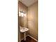 Bathroom featuring a pedestal sink, accent lighting and wood-look flooring at 5580 Jamerson Dr, Atlanta, GA 30349