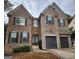 Brick two-story house featuring a two-car garage and dark shutters at 5580 Jamerson Dr, Atlanta, GA 30349