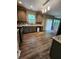 Kitchen with stainless appliances, wood floors, and sliding door access to the backyard at 5580 Jamerson Dr, Atlanta, GA 30349
