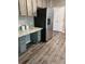 Kitchen featuring stainless steel fridge, light counters and ample cabinet storage at 5580 Jamerson Dr, Atlanta, GA 30349
