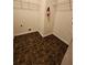 Spacious laundry room with tiled floors and wire shelving, offering ample storage solutions at 5580 Jamerson Dr, Atlanta, GA 30349