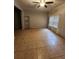 Tile-floored living room featuring a ceiling fan and a metal shelf at 5580 Jamerson Dr, Atlanta, GA 30349