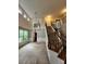 Bright living room with large windows, staircase, and decorative chandelier at 5580 Jamerson Dr, Atlanta, GA 30349