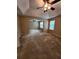 The living room with carpet flooring, neutral walls, vaulted ceiling, and two large windows at 5580 Jamerson Dr, Atlanta, GA 30349