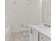 Bright bathroom featuring a white vanity, toilet, and a bathtub with a tiled floor at 6330 Garden Cir, Douglasville, GA 30135