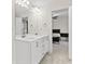 Bathroom with double vanity, large mirror, and view to the bedroom at 6330 Garden Cir, Douglasville, GA 30135