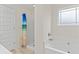 Modern bathroom with a white tub, frosted window, and separate shower at 6330 Garden Cir, Douglasville, GA 30135