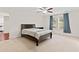 Bedroom with neutral carpet, ceiling fan, and a dark wood bed frame at 6330 Garden Cir, Douglasville, GA 30135