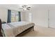 Comfortable bedroom with neutral carpet, ceiling fan, and bright window light at 6330 Garden Cir, Douglasville, GA 30135