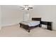 Bedroom with carpet, dark wood bed frame, side table, and a ceiling fan at 6330 Garden Cir, Douglasville, GA 30135