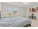 Bright bedroom featuring a large window with outside views and neutral décor at 6330 Garden Cir, Douglasville, GA 30135