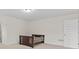 A bright bedroom with neutral carpet and a door leading out at 6330 Garden Cir, Douglasville, GA 30135