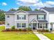 Charming two-story townhome featuring a well-manicured lawn and inviting front entrance at 6330 Garden Cir, Douglasville, GA 30135