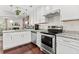 Updated kitchen featuring stainless steel appliances, granite countertops, and a view to the living room at 6330 Garden Cir, Douglasville, GA 30135