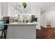 Bright kitchen with white cabinets, granite countertops, stainless appliances, and an open view to the laundry room at 6330 Garden Cir, Douglasville, GA 30135