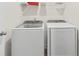 Bright laundry room featuring a modern washer and dryer set with wire shelving at 6330 Garden Cir, Douglasville, GA 30135