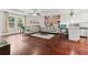 Spacious living room with a tray ceiling, recessed lighting, wood floors, and an open view to the kitchen at 6330 Garden Cir, Douglasville, GA 30135