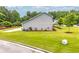 Side yard featuring lush green grass and neatly trimmed shrubs, and a landscaped curb at 6330 Garden Cir, Douglasville, GA 30135