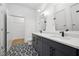 Modern bathroom featuring a double vanity, stylish black and white flooring, and a walk-in closet for ample storage at 112 Rogers Ne St # 304, Atlanta, GA 30317
