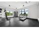 Spacious gym with exercise equipment, including treadmill, stationary bike, and weight bench, illuminated by large windows at 112 Rogers Ne St # 304, Atlanta, GA 30317