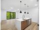 Bright living area with floor-to-ceiling windows and a modern kitchen island with stainless steel sink at 112 Rogers Ne St # 304, Atlanta, GA 30317