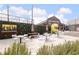 Inviting outdoor seating area with picnic tables and umbrellas, perfect for relaxing and enjoying the outdoors at 112 Rogers Ne St # 304, Atlanta, GA 30317