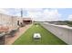Outdoor rooftop space with grilling area, dining tables, lounge chairs, and a cornhole game, perfect for entertaining at 112 Rogers Ne St # 304, Atlanta, GA 30317