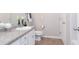 Bathroom features granite countertops, a toilet, and convenient storage space at 240 Orchard Dr, Covington, GA 30014