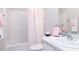 Bathroom with a shower/tub combo, vanity with sink, and pink accents at 240 Orchard Dr, Covington, GA 30014