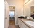 Well-lit bathroom featuring a granite countertop, stylish fixtures, and open access to the main bedroom at 240 Orchard Dr, Covington, GA 30014