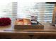 A variety of snacks, drinks, and supplies are nicely arranged on a wooden desk at 240 Orchard Dr, Covington, GA 30014