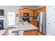 Well-equipped kitchen featuring stainless steel appliances, granite countertops, and wooden cabinetry at 240 Orchard Dr, Covington, GA 30014