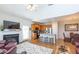 Bright, open floor plan featuring a fireplace, kitchen island with bar stools, and hardwood floors at 240 Orchard Dr, Covington, GA 30014