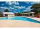 Community pool area with ample seating, a covered pavilion, and a clubhouse at 240 Orchard Dr, Covington, GA 30014
