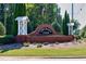Entrance to Orchard Park with brick signage and flagpole at 240 Orchard Dr, Covington, GA 30014