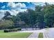 Community tennis court and green space with shade trees at 240 Orchard Dr, Covington, GA 30014