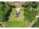 Aerial view of property showcasing the home, large lot, driveway, and surrounding trees at 3950 Chattahoochee Rd, Cumming, GA 30041