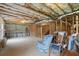 Spacious basement showing ceiling insulation and framing with chair and work bench at 3950 Chattahoochee Rd, Cumming, GA 30041