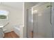 Bright bathroom featuring a glass-enclosed shower, bathtub and white fixtures at 3950 Chattahoochee Rd, Cumming, GA 30041