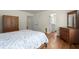 Bedroom featuring a wooden bed, two dressers and hardwood floors at 3950 Chattahoochee Rd, Cumming, GA 30041