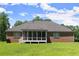 Brick home on large grassy lot with attached garage, screened porch and mature trees at 3950 Chattahoochee Rd, Cumming, GA 30041